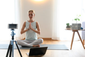 Yoga teacher, 40+ gives online yoga classes. Online video yoga class using a smartphone. Yoga teacher, 40+ gives online yoga classes. Online video yoga class using a smartphone.